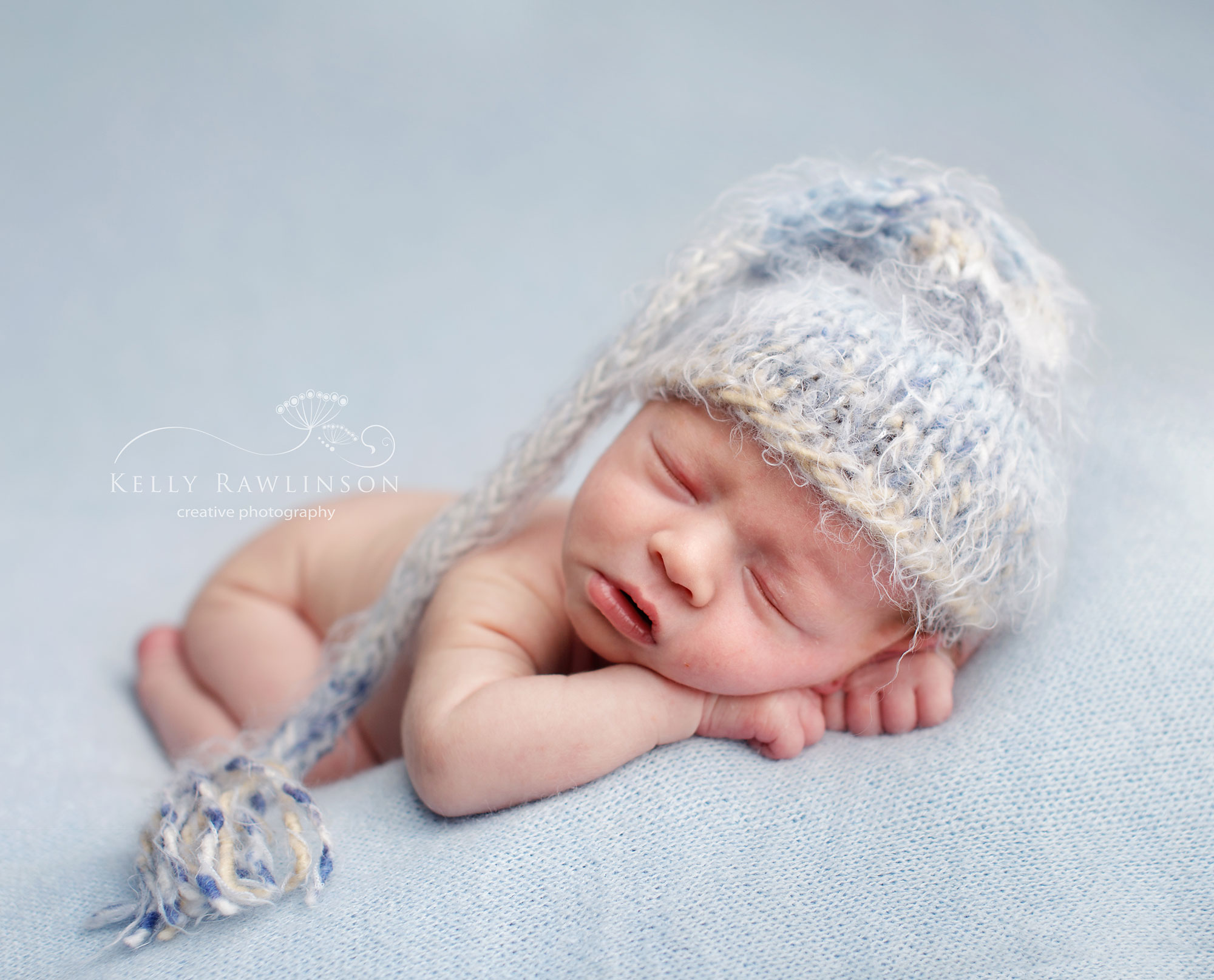 newborn boy on Baby blue backdrop