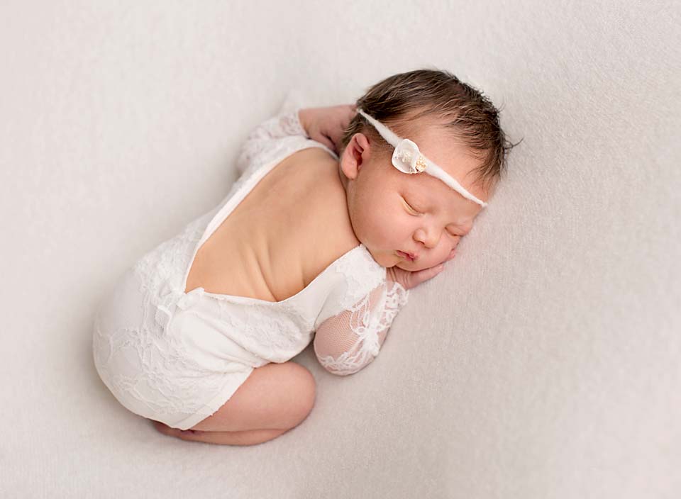 Baby girl sleeping in sweet lacey romper, newborn photography in Keswick Ontario