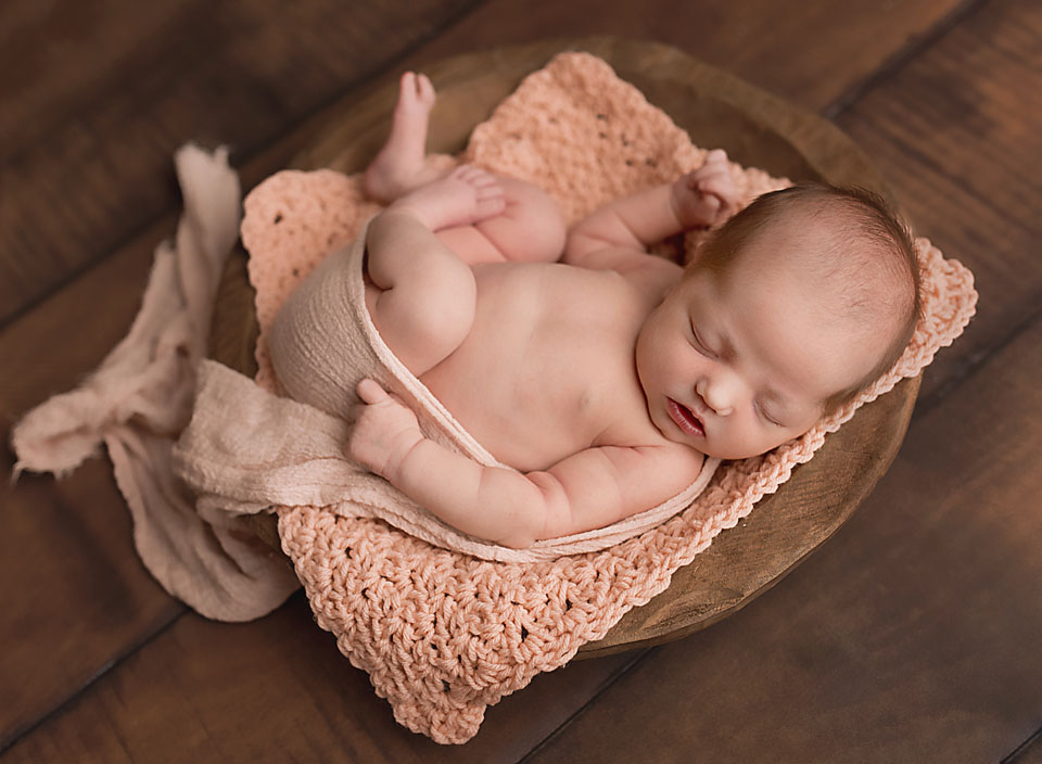 Keswick newborn photographer poses new baby to sleep on her back