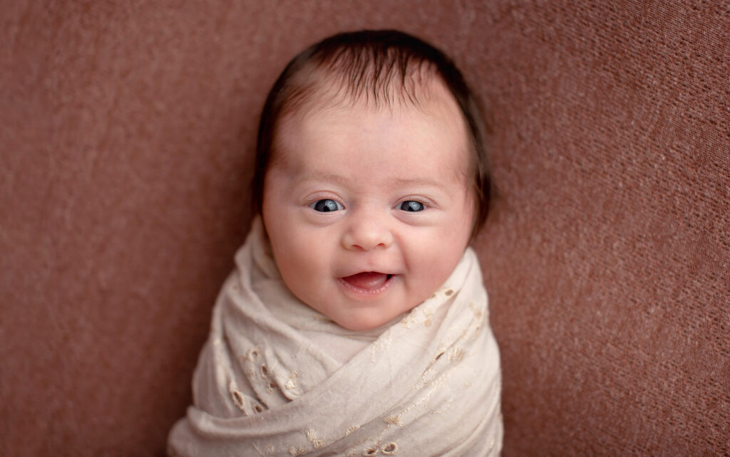 Professional photos of happy smiling newborn baby girl