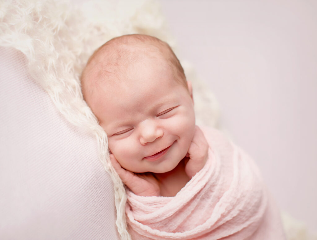 Newborn Photographer captures smile from baby girl